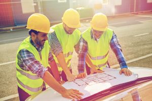 Contractors looking over a building plan with confidence