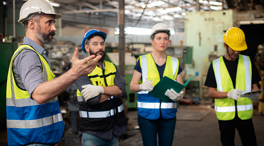 group of technicians standing around in safety gear 