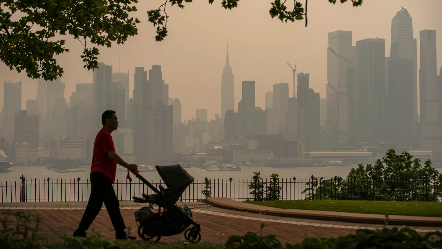 Haze from wildfires turns the New York City skyline yellow.