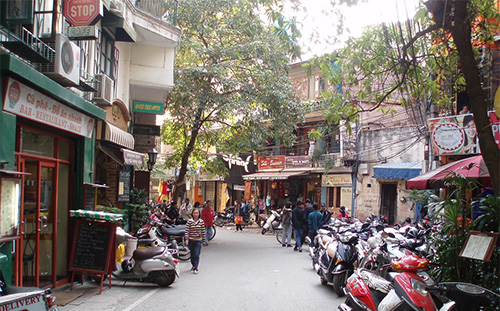 Hanoi—Old City Street scene in Hanoi’s Old Quarter showing narrow roads and motorbikes, where tunneling for Metro Line 2 faces tight clearances and heritage-site challenges.